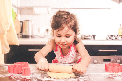 Portrait of happy girl with ice cream on table