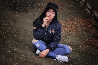 Young woman sitting on field