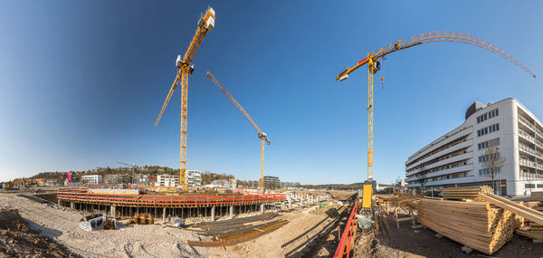 Panoramic view of construction site against sky in city