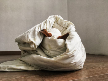 Midsection of woman sitting on floor at home