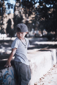 Portrait of smiling boy standing against river