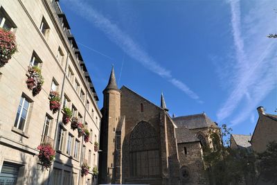 Low angle view of buildings against blue sky