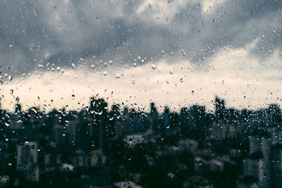 Full frame shot of wet glass window in rainy season