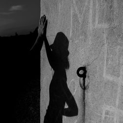 Shadow of man and woman standing on street