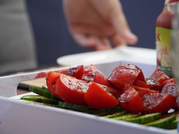 Close-up of person preparing food in plate