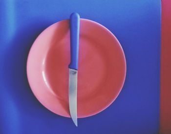 High angle view of empty red and blue table against white background