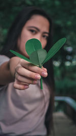Close-up of woman holding plant