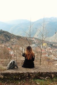 Rear view of woman on landscape against sky