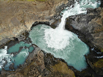 High angle view of rocks in sea