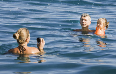 Family swimming in water