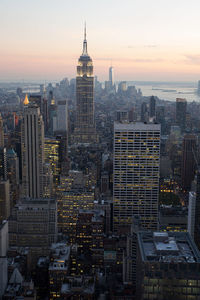 Aerial view of city lit up at sunset