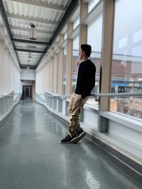 Full length of young man standing in corridor