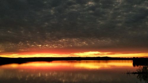 Scenic view of lake against orange sky