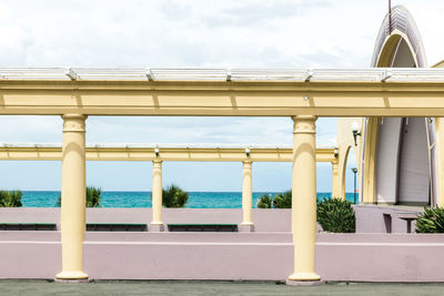 Bridge over sea against buildings in city