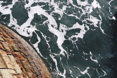 Directly above view of cliff in sea