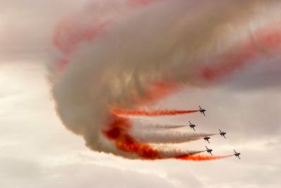 Low angle view of airshow against sky