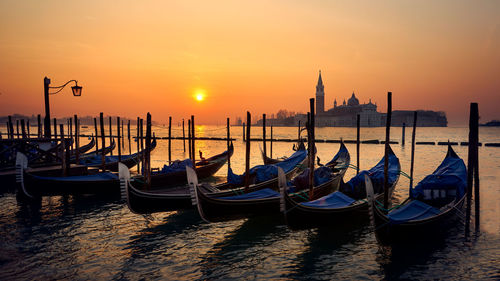 View of boats in sea at sunset