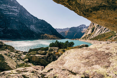 Scenic view of river and mountains against sky