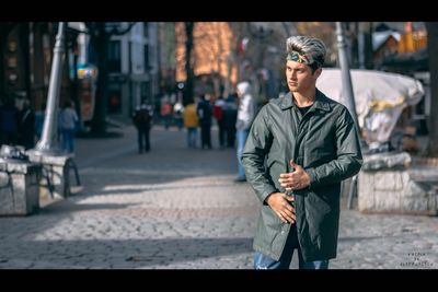 Young man standing on city street