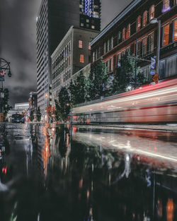 Reflection of illuminated buildings in city at night