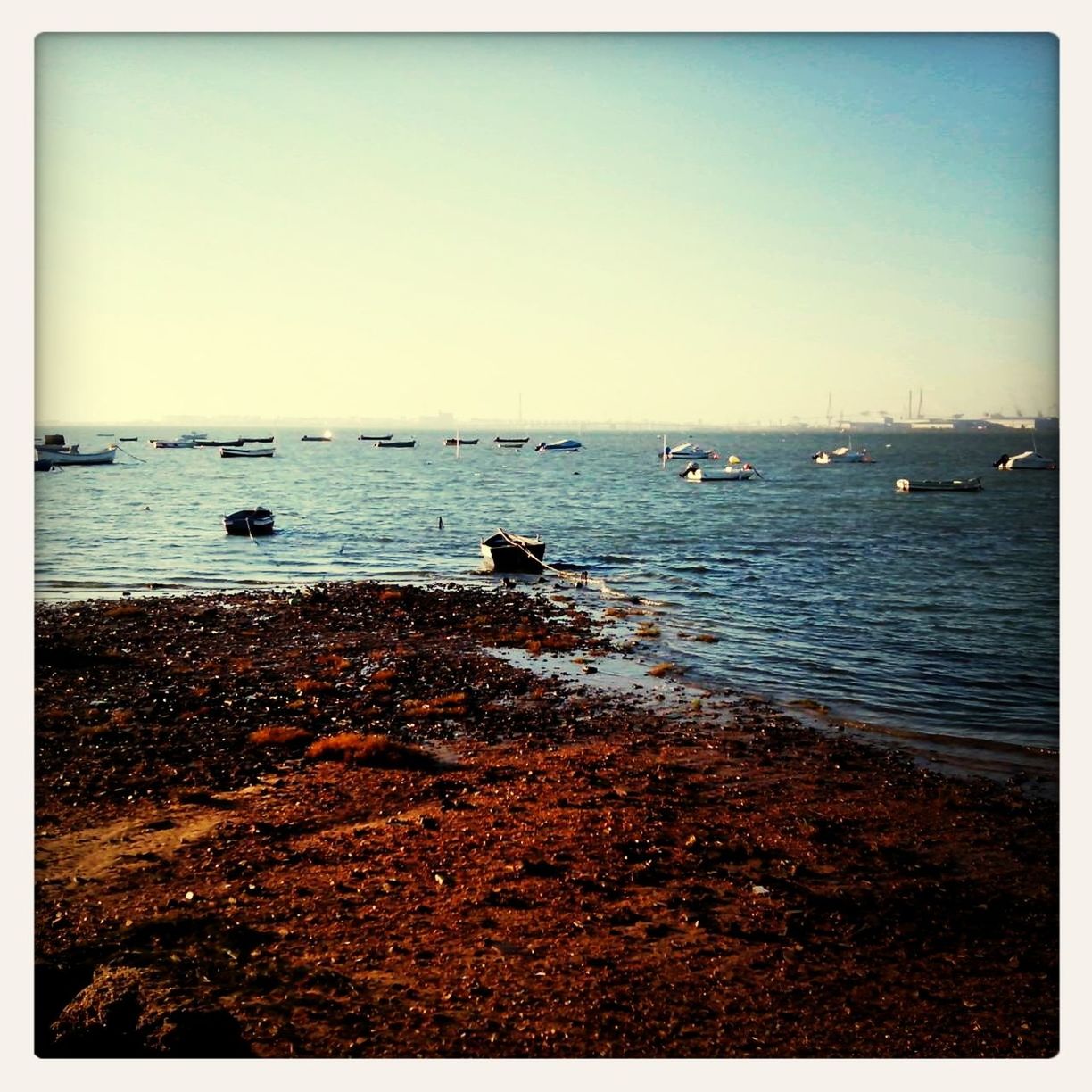 water, sea, transfer print, clear sky, horizon over water, auto post production filter, nautical vessel, transportation, mode of transport, tranquil scene, copy space, tranquility, scenics, beach, boat, beauty in nature, nature, shore, blue, sky