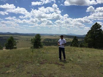 Full length of man standing on field against sky