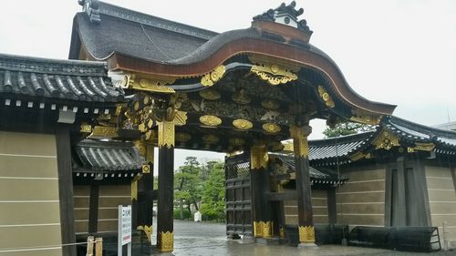 Statue in temple against sky in city