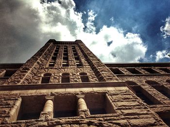 Low angle view of building against cloudy sky