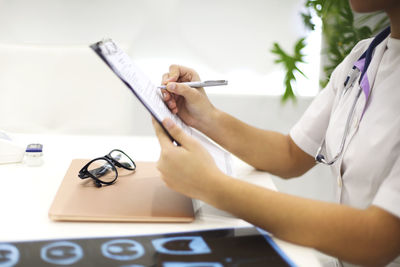 Midsection of doctor working at hospital