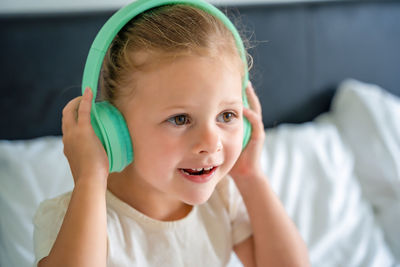 Portrait of young woman with eyes closed headphones