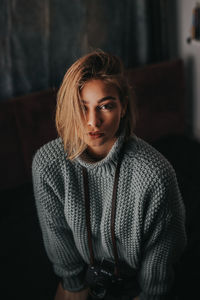 Portrait of beautiful young woman standing at home