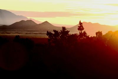 Scenic view of silhouette mountains against sky at sunset