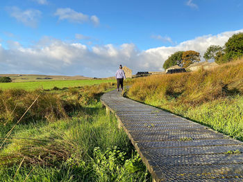 Woman walking on a boardwalk