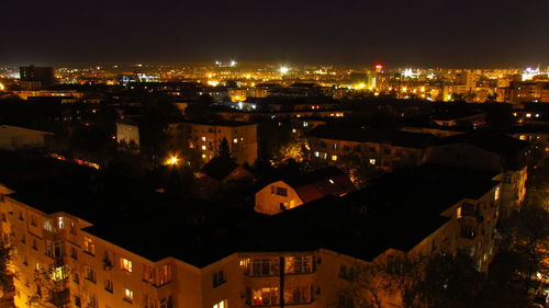 High angle view of illuminated buildings in city at night