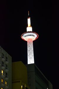 Low angle view of illuminated buildings against sky at night