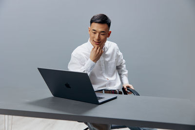 Young man using laptop at desk