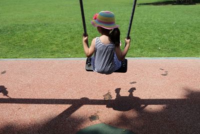 Rear view of child in a swing