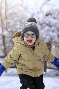 Portrait of boy skiing on snow