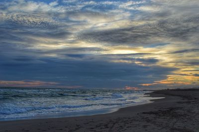 Scenic view of beach against sky during sunset