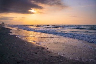 Scenic view of beach against sky during sunset