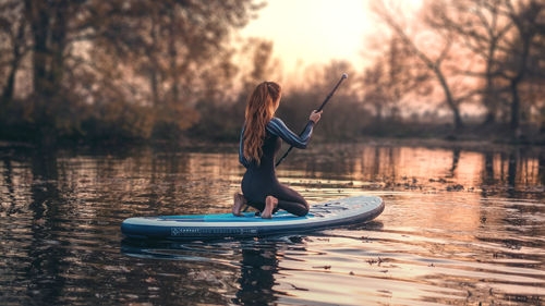 Side view of woman in lake