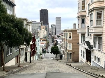 Street amidst buildings in city against sky