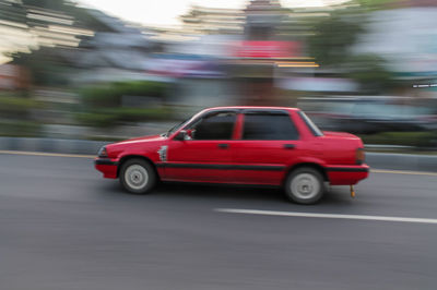 Red car on city street