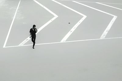 High angle view of man walking on road