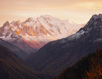 Scenic view of snowcapped mountains against sky during sunset