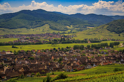 High angle view of townscape and mountains against sky