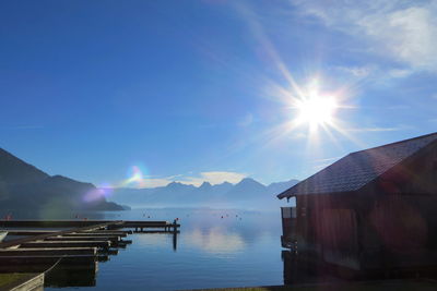 Scenic view of lake against bright sun