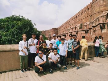 Group of people sitting outside building