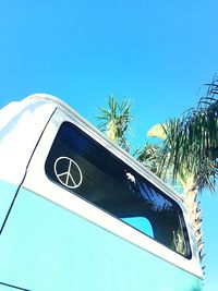Low angle view of trees against clear blue sky