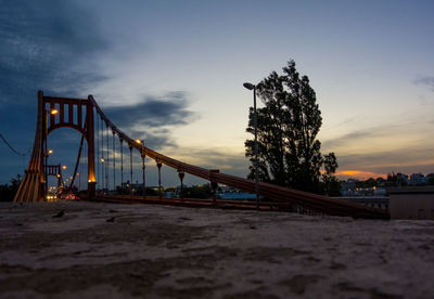 View of suspension bridge against cloudy sky